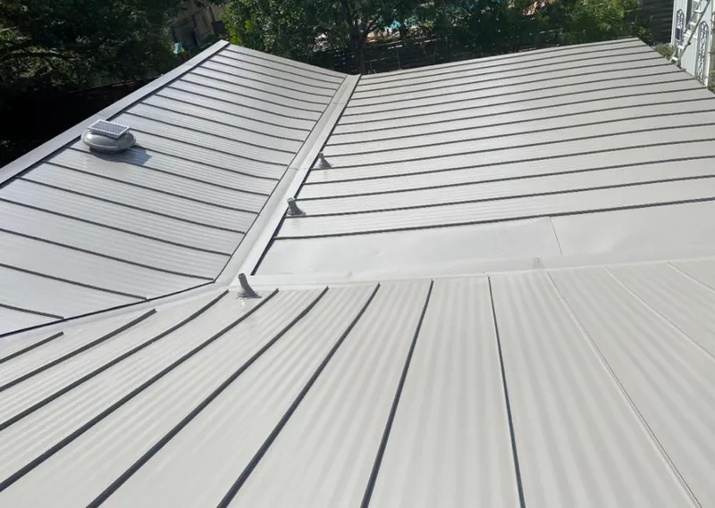 Solar attic fan installed on a metal roof for Roof Ventilation in Carthage